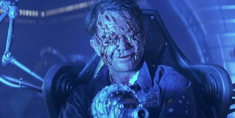 Dr. Billy Weir sits smiling with his eyes gouged out and his face covered in slices in Event Horizon.