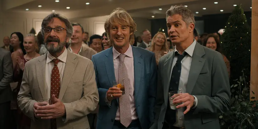 Mitts, Pryce, and Clark in suits standing together with drinks in Stick.